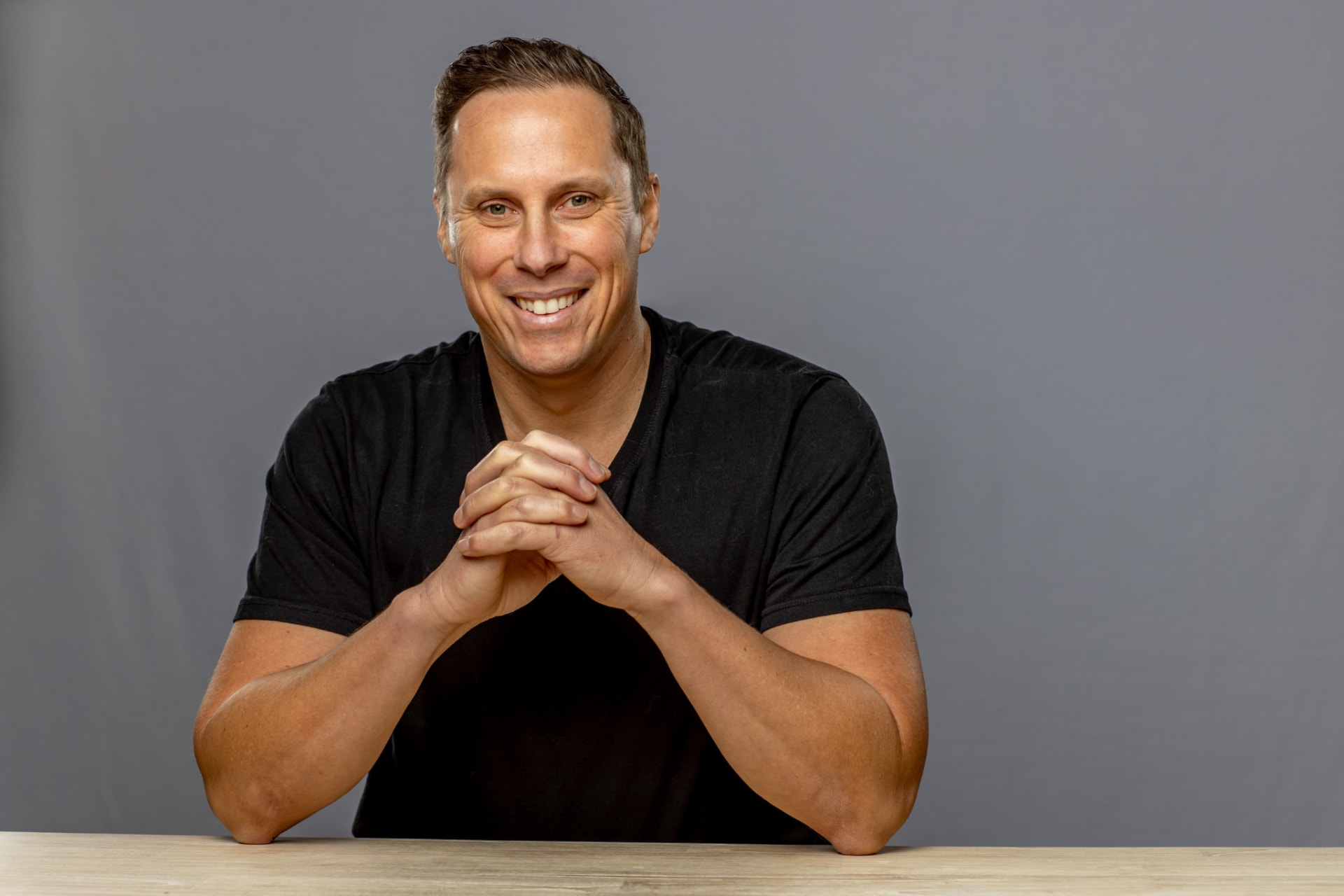 Black shirt, seated at desk (hero)